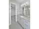 Clean bathroom with vanity, large mirror, and access to bedroom at 2423 Hyatt Creek Ln, Port Orange, FL 32128