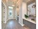Elegant entryway featuring hardwood floors, built-in storage, and stained glass door at 2423 Hyatt Creek Ln, Port Orange, FL 32128