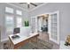 Home office with wood desk, large windows, and plantation shutters at 2423 Hyatt Creek Ln, Port Orange, FL 32128