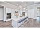 White kitchen with large island and stainless steel appliances at 2423 Hyatt Creek Ln, Port Orange, FL 32128