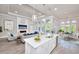 Open kitchen with white cabinets and large island overlooking living room at 2423 Hyatt Creek Ln, Port Orange, FL 32128