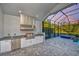 Outdoor kitchen with stainless steel appliances and granite countertops at 2423 Hyatt Creek Ln, Port Orange, FL 32128