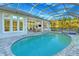 Resort-style pool and spa with screened enclosure at 2423 Hyatt Creek Ln, Port Orange, FL 32128