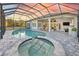 Luxury pool and spa with covered patio and outdoor kitchen at 2423 Hyatt Creek Ln, Port Orange, FL 32128
