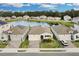 Aerial view of houses and a lake in a residential area at 3087 Camden Way, Davenport, FL 33837