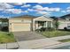 Single-story home with light colored walls and a white garage door at 3087 Camden Way, Davenport, FL 33837