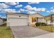 Modern single story home with a brick paved driveway at 3087 Camden Way, Davenport, FL 33837