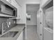 White shaker cabinets, gray countertops, and in-unit laundry at 3087 Camden Way, Davenport, FL 33837