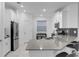 Modern kitchen with gray countertops, white cabinets, and stainless steel appliances at 3087 Camden Way, Davenport, FL 33837