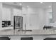 Modern kitchen with gray countertops and white cabinets at 3087 Camden Way, Davenport, FL 33837