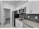 Modern kitchen with stainless steel appliances and gray tile backsplash at 3087 Camden Way, Davenport, FL 33837