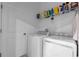 Laundry room with washer, dryer, and shelving at 3087 Camden Way, Davenport, FL 33837