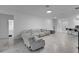 Open living room with sectional sofa and view of kitchen at 3087 Camden Way, Davenport, FL 33837