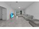 Living room with sectional sofa and large window overlooking backyard at 3087 Camden Way, Davenport, FL 33837