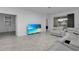 Bright living room with sectional sofa and flat-screen TV at 3087 Camden Way, Davenport, FL 33837