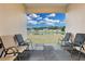 Relaxing patio with seating overlooking a pond at 3087 Camden Way, Davenport, FL 33837