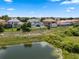 An aerial view shows this lovely home nestled among other residences and adjacent to a small lake at 408 Chelsea Ave, Davenport, FL 33837