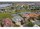 Aerial view showcases this property in a neighborhood setting with water views and mature trees at 408 Chelsea Ave, Davenport, FL 33837