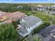 Aerial view of a two-story home with well maintained landscaping, and a nearby body of water at 408 Chelsea Ave, Davenport, FL 33837