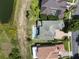 This aerial view shows the roof as well as the pool and a landscaped garden at 408 Chelsea Ave, Davenport, FL 33837