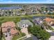 Aerial view of an estate home that backs up to a lake, surrounded by lush tropical landscaping at 408 Chelsea Ave, Davenport, FL 33837