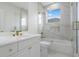 Modern bathroom with white marble, glass shower doors, and a built-in toiletry alcove at 408 Chelsea Ave, Davenport, FL 33837