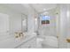 Modern bathroom with double vanity, white marble countertops, and glass enclosed shower and tub at 408 Chelsea Ave, Davenport, FL 33837
