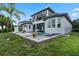 A luxury backyard featuring a pool, spa, balcony, brick pavers, and manicured landscaping for an opulent outdoor experience at 408 Chelsea Ave, Davenport, FL 33837