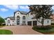 Beautiful two-story home has a brick driveway and detailed landscaping at 408 Chelsea Ave, Davenport, FL 33837