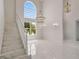 Bright foyer features soaring ceilings, a grand staircase, large windows, and elegant lighting at 408 Chelsea Ave, Davenport, FL 33837