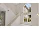 Bright foyer featuring staircase, chandelier, and large windows at 408 Chelsea Ave, Davenport, FL 33837