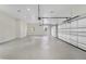 Spacious garage with epoxy flooring, an automatic door, recessed lighting, and plenty of storage at 408 Chelsea Ave, Davenport, FL 33837