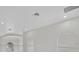 Second-floor hallway with white walls, decorative archways, and recessed lighting at 408 Chelsea Ave, Davenport, FL 33837