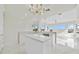 Open kitchen features an island, white countertops and marble flooring at 408 Chelsea Ave, Davenport, FL 33837