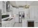 Gourmet kitchen features stainless steel appliances, a wine cooler, and custom cabinetry at 408 Chelsea Ave, Davenport, FL 33837