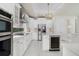 Modern kitchen features stainless steel appliances and white cabinetry at 408 Chelsea Ave, Davenport, FL 33837