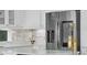 White cabinets and stainless steel refrigerator at 408 Chelsea Ave, Davenport, FL 33837
