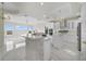 An open-concept room featuring a large kitchen with white cabinets, a stone-clad island, and luxurious lighting at 408 Chelsea Ave, Davenport, FL 33837