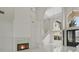 Bright living room with a fireplace, tall ceilings, staircase, and chandelier at 408 Chelsea Ave, Davenport, FL 33837