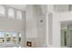 Spacious living room with a fireplace, tall ceilings, and backyard views at 408 Chelsea Ave, Davenport, FL 33837