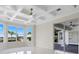 Spacious main bedroom featuring white marble floors, coffered ceilings, and sliding glass doors to the lanai at 408 Chelsea Ave, Davenport, FL 33837