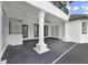 Covered outdoor living space featuring a ceiling fan, tiled flooring, and access to backyard at 408 Chelsea Ave, Davenport, FL 33837