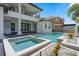 Backyard featuring pool, spa, covered balcony, pavers, landscaping, and elegant design; ideal for luxury outdoor living at 408 Chelsea Ave, Davenport, FL 33837