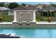 Luxury pool featuring a decorative fountain with lion heads and lush landscaping in a well maintained backyard setting at 408 Chelsea Ave, Davenport, FL 33837
