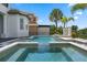 Backyard pool and spa area featuring a unique lion head fountain and tropical landscaping. Perfect for relaxation at 408 Chelsea Ave, Davenport, FL 33837