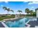 An inviting backyard pool and spa with a decorative lion head fountain and tropical landscaping in a relaxing setting at 408 Chelsea Ave, Davenport, FL 33837