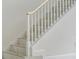 Elegant staircase with white railings and marble steps, accented with gold trim at 408 Chelsea Ave, Davenport, FL 33837