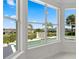 Bright sunroom featuring large windows with views of the backyard and pool area at 408 Chelsea Ave, Davenport, FL 33837