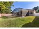 Landscaped backyard featuring a screened pool at 6490 Everingham Ln, Sanford, FL 32771