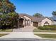 Beautiful one-story home with stone accents and a large driveway at 6490 Everingham Ln, Sanford, FL 32771